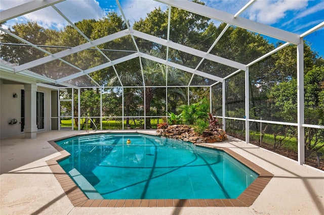 view of pool with a patio and a lanai