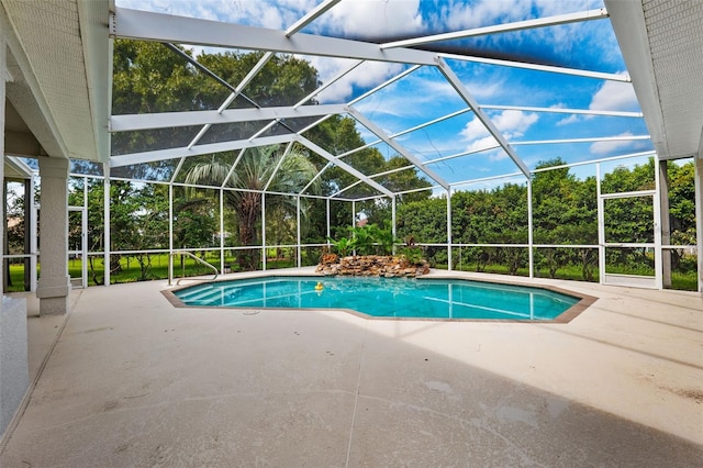 view of swimming pool featuring a lanai and a patio area