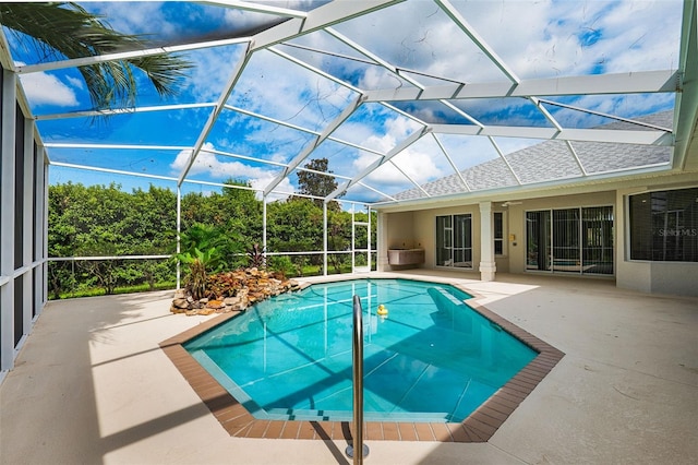 view of pool with a lanai and a patio area