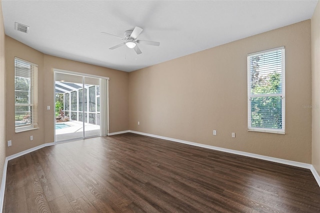 empty room featuring ceiling fan and dark hardwood / wood-style flooring