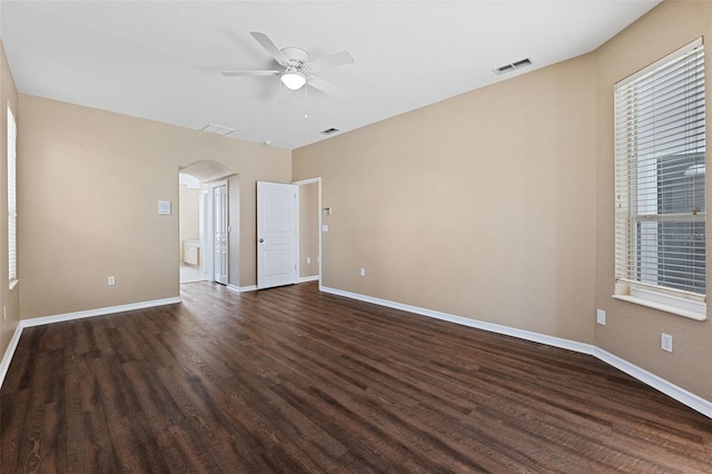 unfurnished room with ceiling fan and dark wood-type flooring