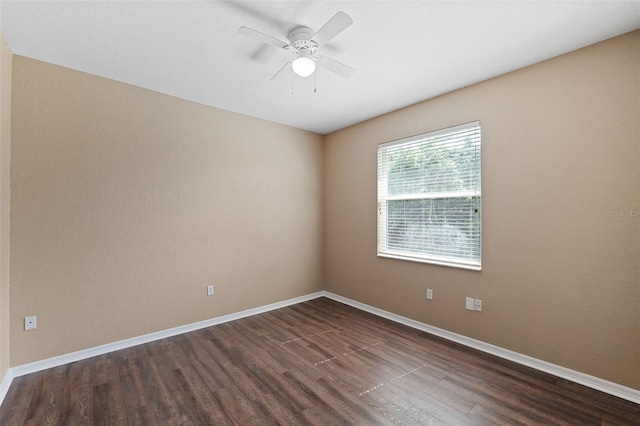 spare room with ceiling fan and dark wood-type flooring