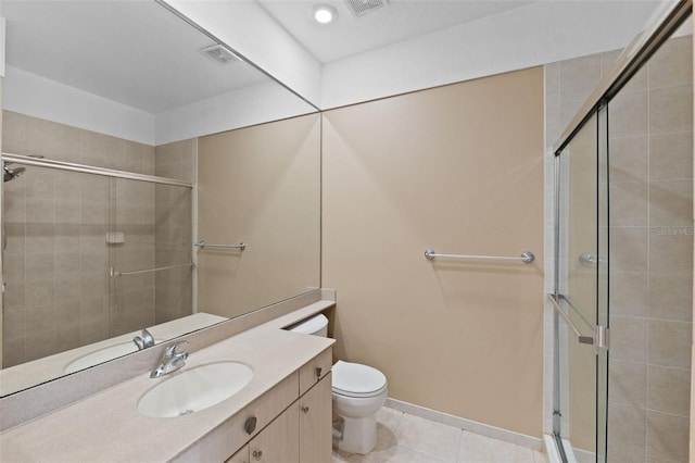 bathroom featuring vanity, a shower with shower door, toilet, and tile patterned floors