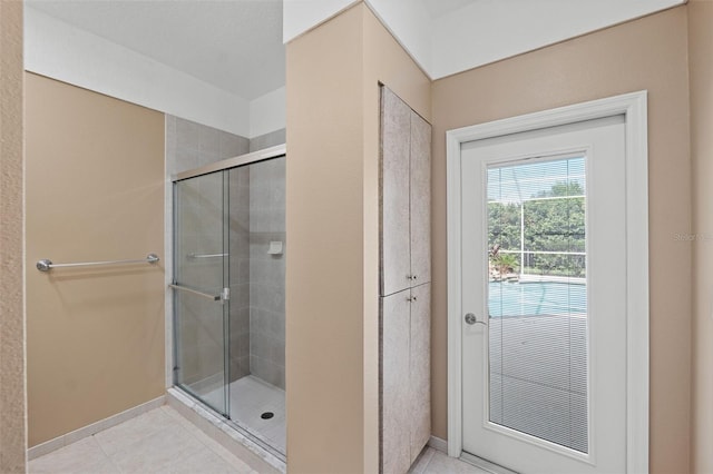 bathroom with tile patterned flooring and a shower with shower door