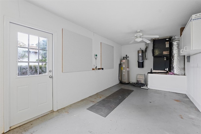 garage featuring ceiling fan, heating unit, and electric water heater