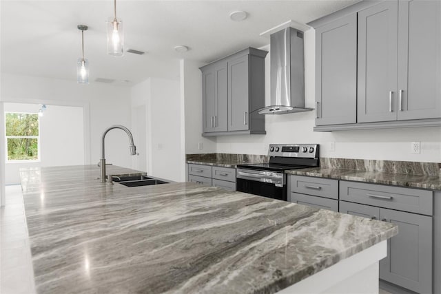 kitchen featuring dark stone counters, sink, wall chimney exhaust hood, and electric range