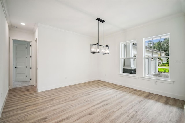 unfurnished dining area with ornamental molding, light hardwood / wood-style flooring, and a notable chandelier