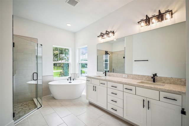 bathroom with vanity, plus walk in shower, and tile patterned flooring