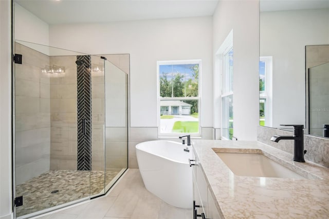 bathroom with vanity, tile patterned flooring, and plus walk in shower