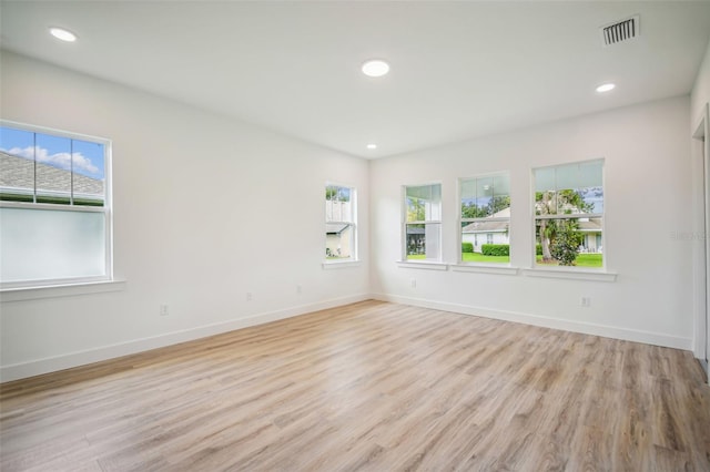 unfurnished room with light hardwood / wood-style floors and a wealth of natural light