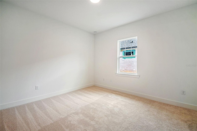 unfurnished room with light colored carpet