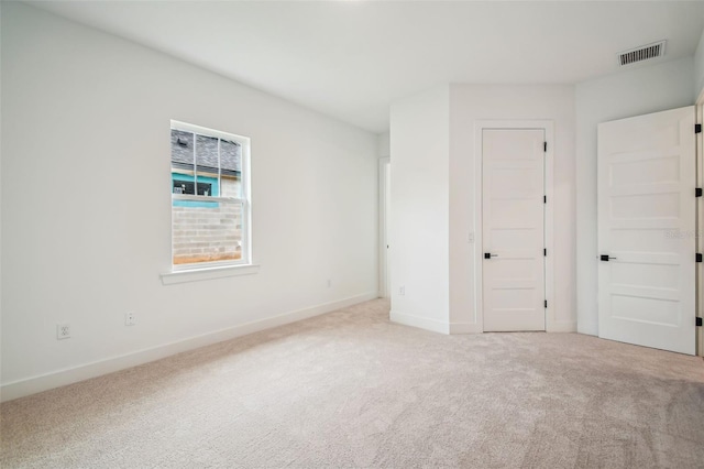 unfurnished bedroom featuring light carpet