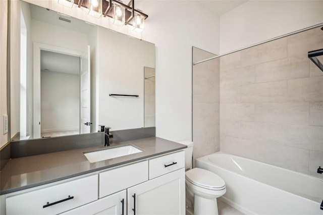 full bathroom featuring vanity, tiled shower / bath combo, and toilet