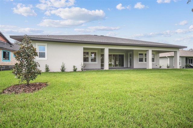 back of property featuring a yard