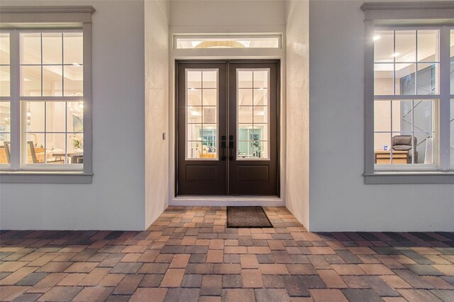 property entrance with french doors and stucco siding