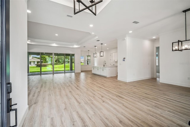 unfurnished living room featuring baseboards, light wood finished floors, visible vents, and recessed lighting