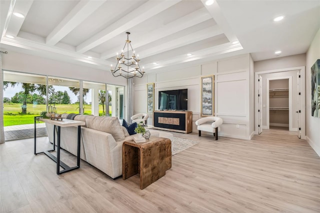 living room featuring beam ceiling, a notable chandelier, recessed lighting, light wood-type flooring, and baseboards