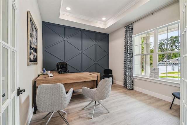 home office with recessed lighting, baseboards, light wood-style floors, ornamental molding, and a raised ceiling