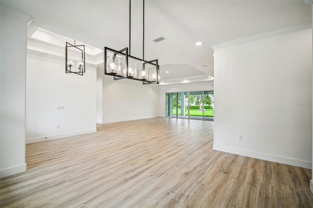 interior space with recessed lighting, visible vents, baseboards, light wood-type flooring, and a raised ceiling