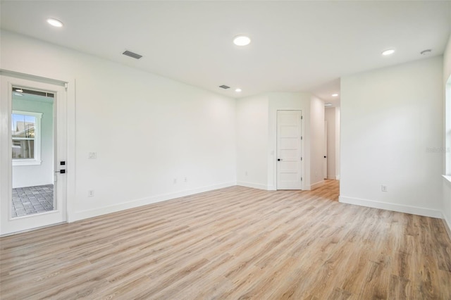 spare room featuring recessed lighting, baseboards, visible vents, and light wood finished floors