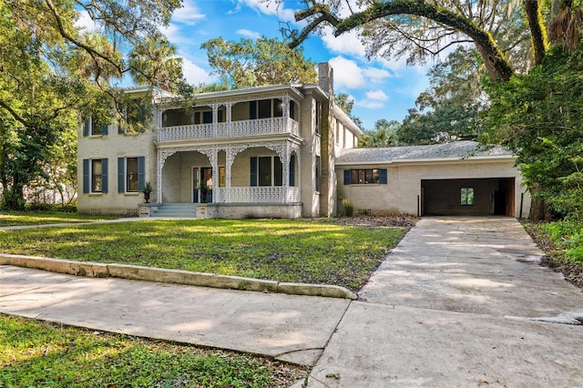 view of front of property featuring a balcony and a front lawn