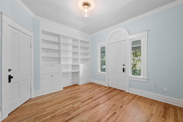 foyer featuring ornamental molding and light hardwood / wood-style flooring