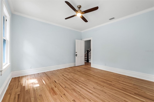 spare room featuring crown molding, light hardwood / wood-style floors, and ceiling fan