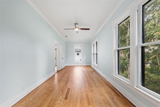 unfurnished room with ceiling fan, light wood-type flooring, and crown molding