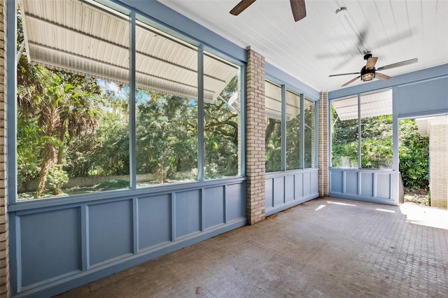 unfurnished sunroom with ceiling fan