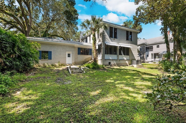 back of house with a lawn