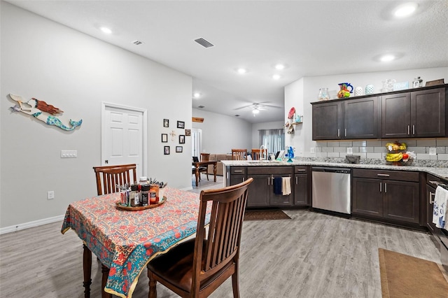 dining room with ceiling fan, a textured ceiling, light hardwood / wood-style flooring, and sink