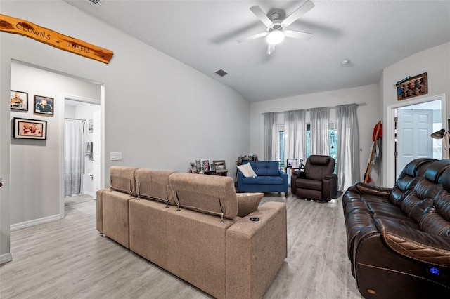 living room featuring light wood-type flooring, vaulted ceiling, and ceiling fan