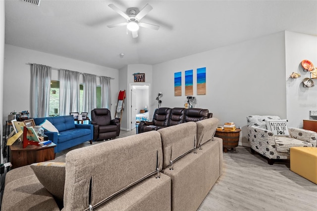 living room with ceiling fan and light wood-type flooring