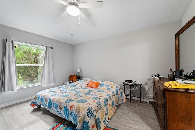 bedroom with light hardwood / wood-style flooring and ceiling fan