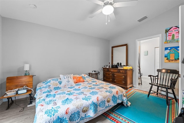 bedroom featuring lofted ceiling, ceiling fan, and light hardwood / wood-style flooring