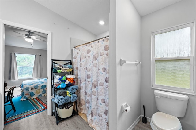 bathroom with wood-type flooring, vaulted ceiling, ceiling fan, and toilet