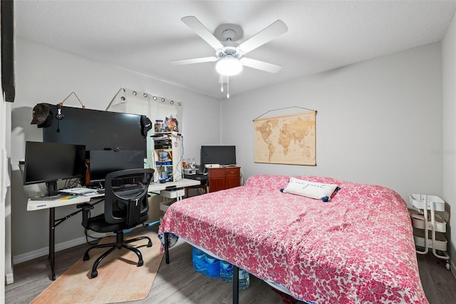 bedroom with ceiling fan and hardwood / wood-style flooring