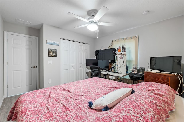 bedroom featuring ceiling fan, a closet, and wood-type flooring