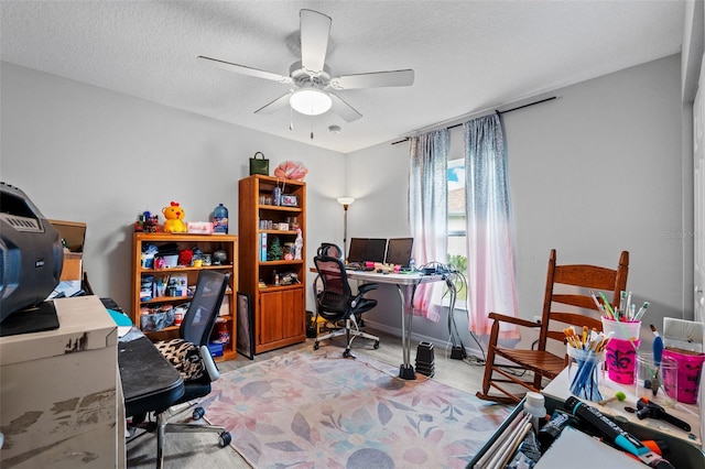 office area featuring ceiling fan and a textured ceiling