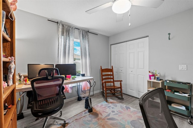 office space with light wood-type flooring and ceiling fan