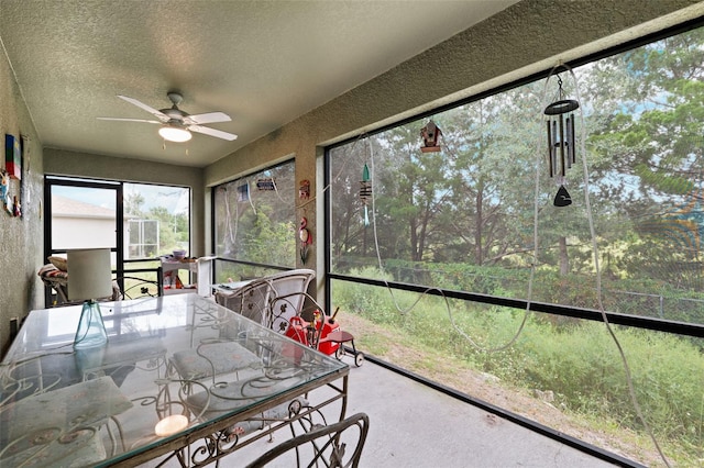 sunroom / solarium featuring ceiling fan