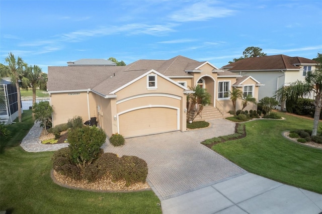 view of front of house featuring a garage and a front lawn