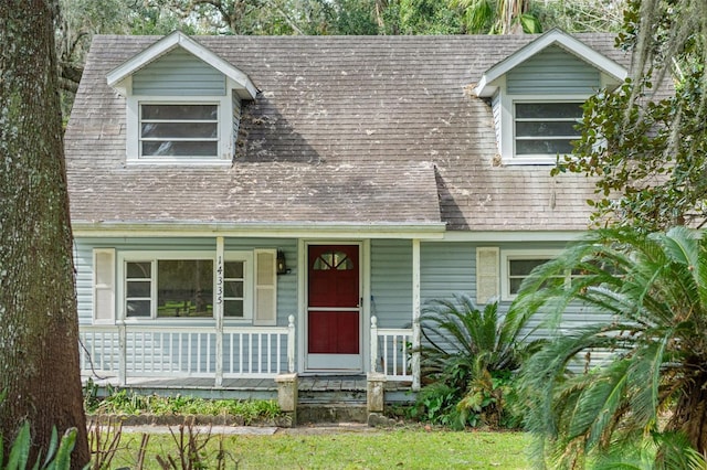 cape cod-style house featuring a porch