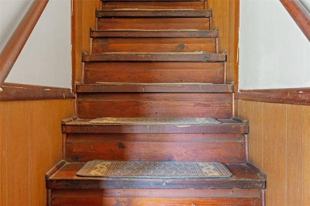 stairs featuring wooden walls