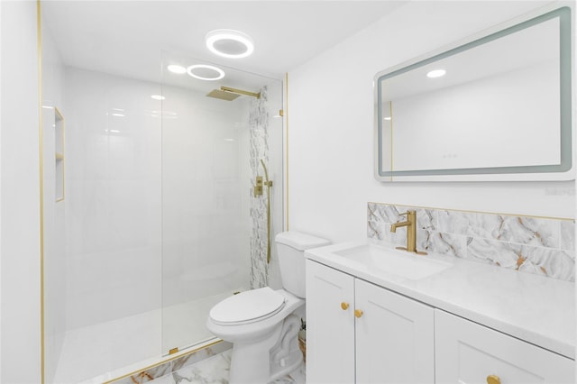 bathroom with toilet, vanity, and a tile shower