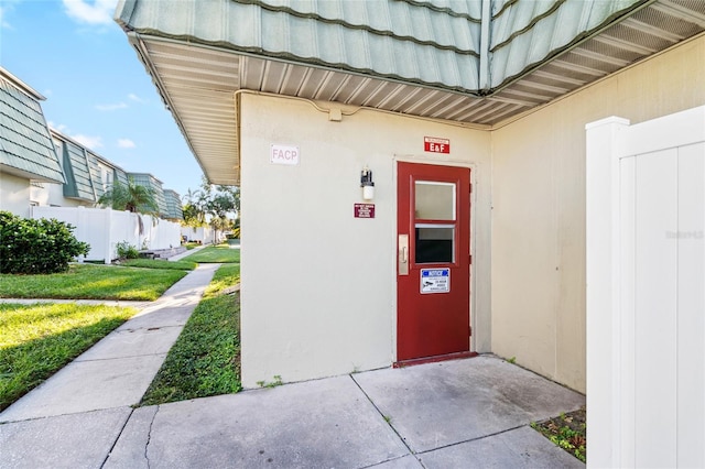 doorway to property with a yard