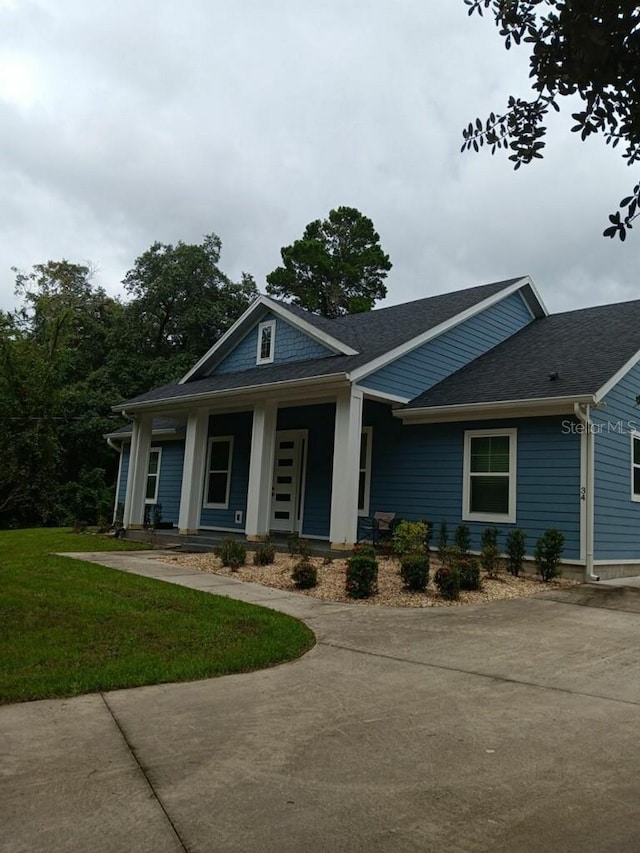 view of front of property with a front yard and a porch