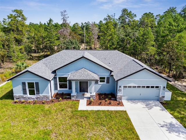 view of front of property featuring a garage and a front yard