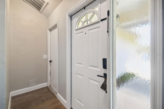 entryway with dark hardwood / wood-style flooring