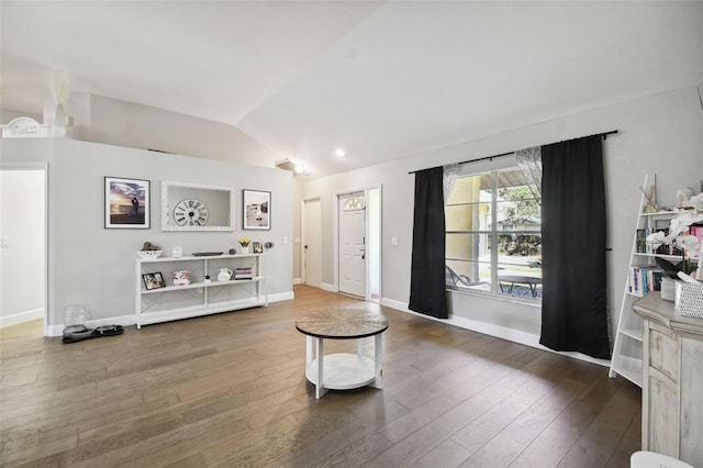 living room featuring hardwood / wood-style floors and vaulted ceiling